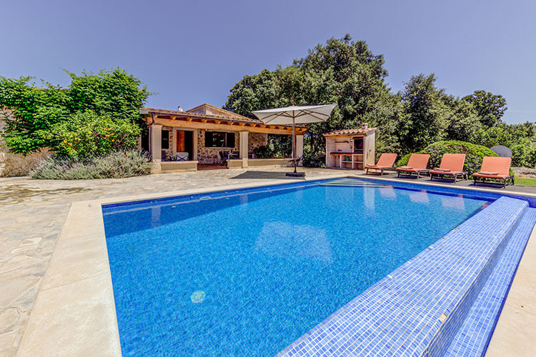Private pool with sun loungers and a shaded terrace in peaceful landscaped surroundings...