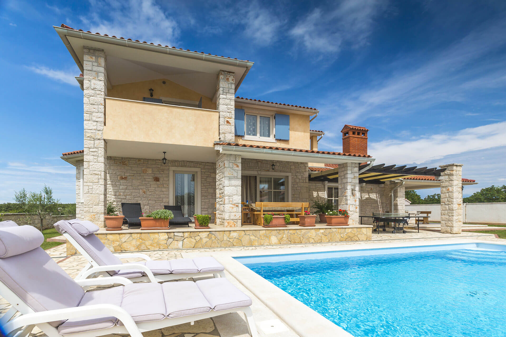 Well-maintained holiday villa with private pool, sun loungers, and landscaped terrace, showcasing quality property management and guest-ready presentation.
